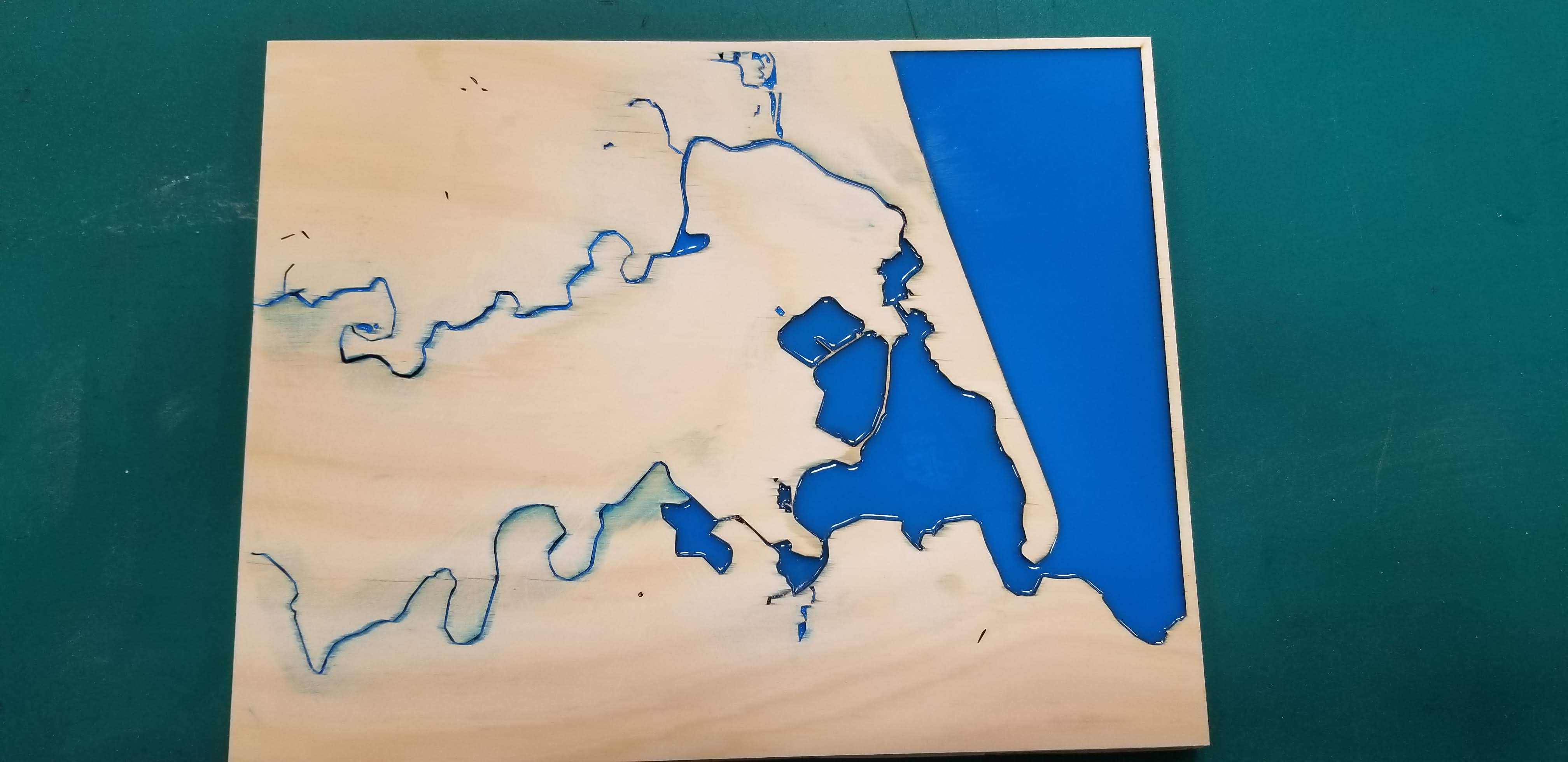 Gluing land layer and pouring blue epoxy for the sea